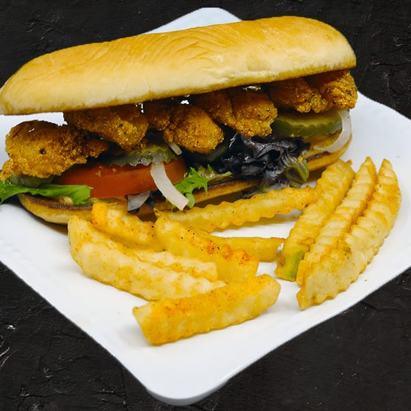Fishbone Seafood's fried shrimp po'boy with lettuce, tomato, pickles, and a side of crinkle-cut fries.