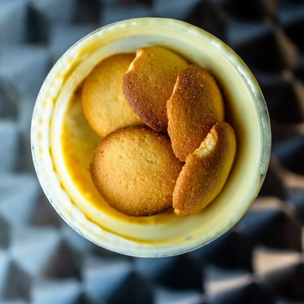Overhead view of vanilla wafers in a cup of banana pudding from Fishbone Seafood.